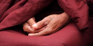 an-old-monk-in-meditation-with-hands-putting-together