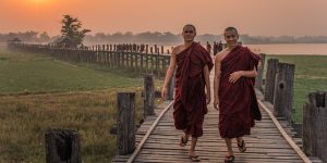 two-monks-walking-on-the-u-bein-bridge-at-sunset