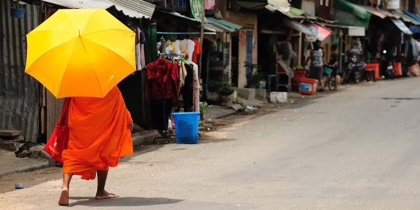 a-monk-walking-on-the-street-of-phnom-penh